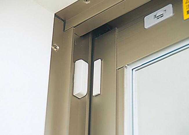 窓の上部に設置された防犯センサーの写真