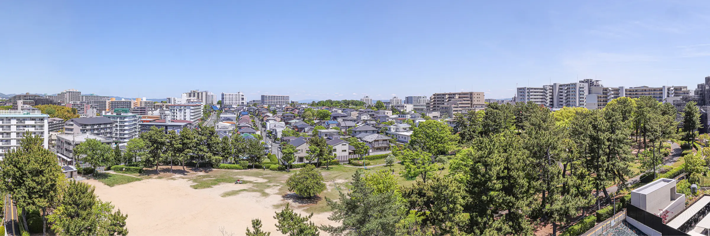 現地8階相当の高さから望む竹見公園と周辺の街並み